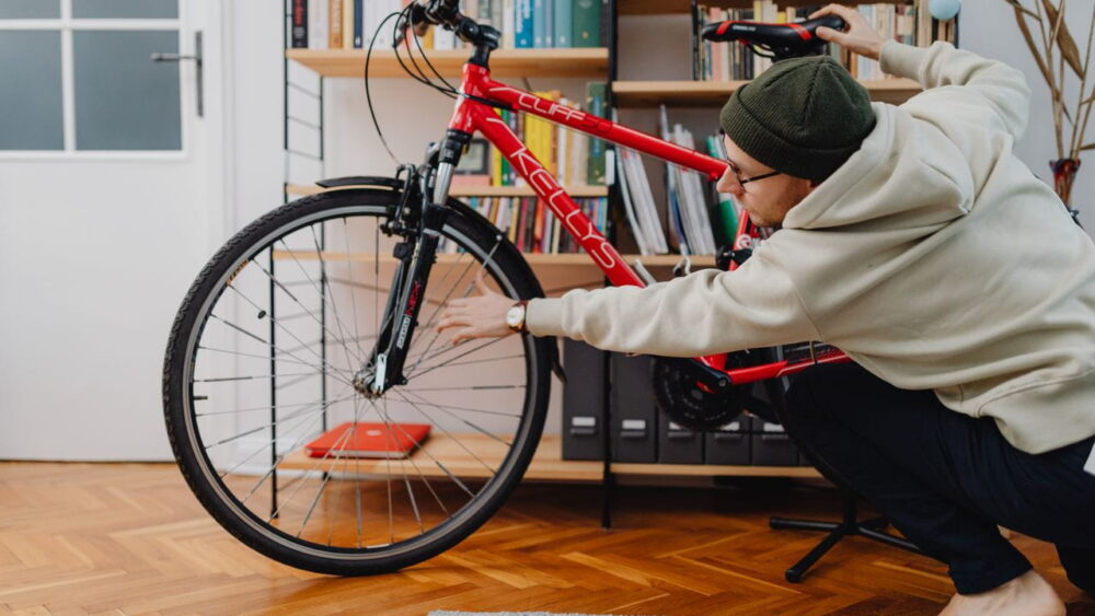 Person adjusting the saddle height on a bicycle